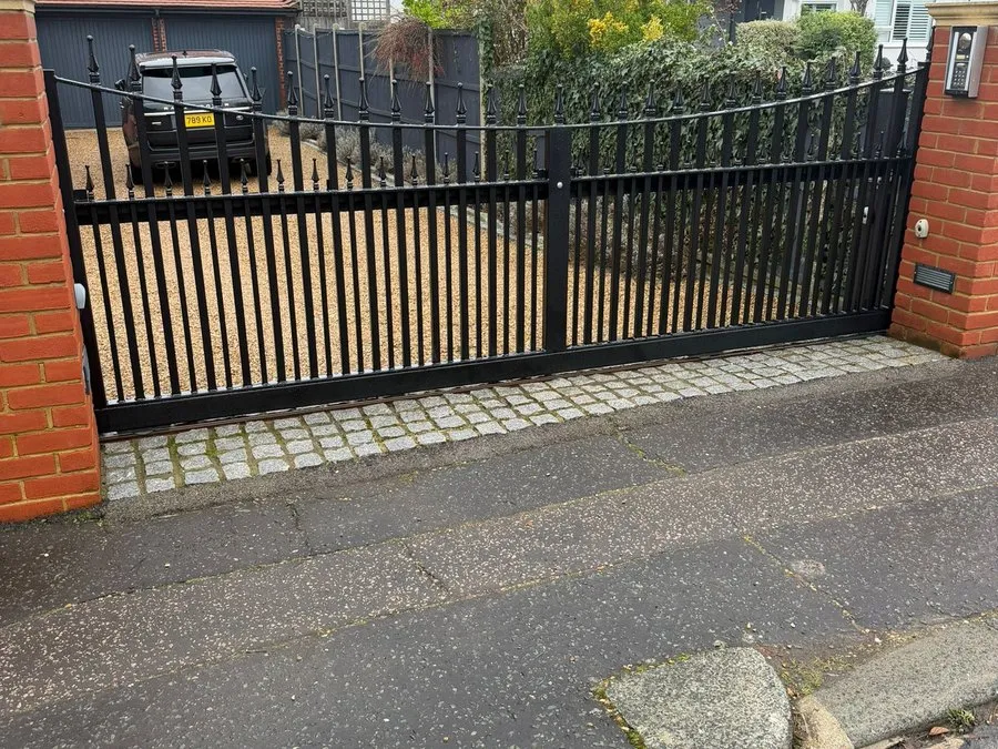 Automated gates in Harlow with brick piers and a block paved driveway