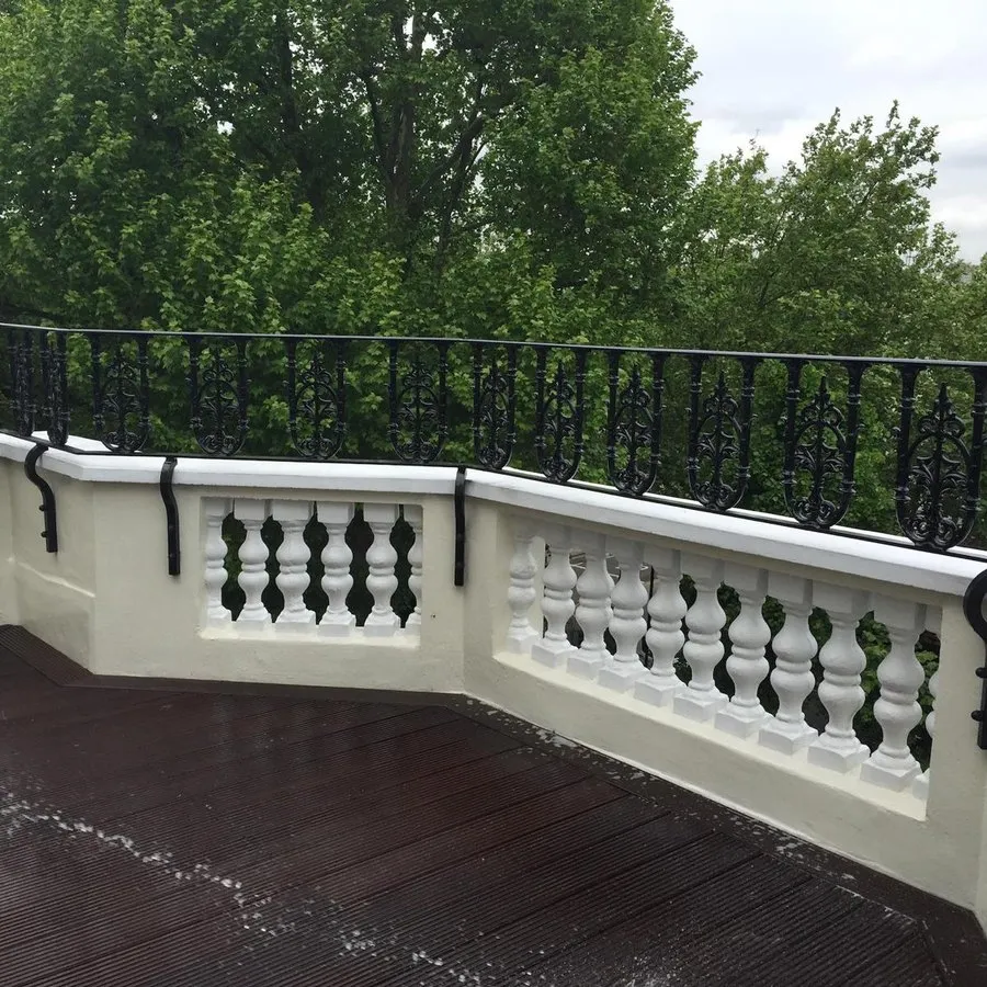 Balcony railings in Harlow set into a rendered balustrade on a roof terrace