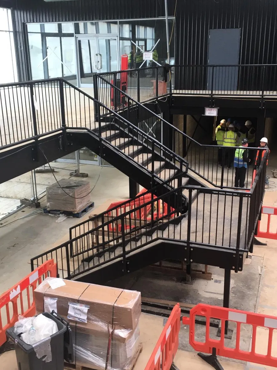MRI Fabrications team installing a steel staircase and balustrade on site near Harlow