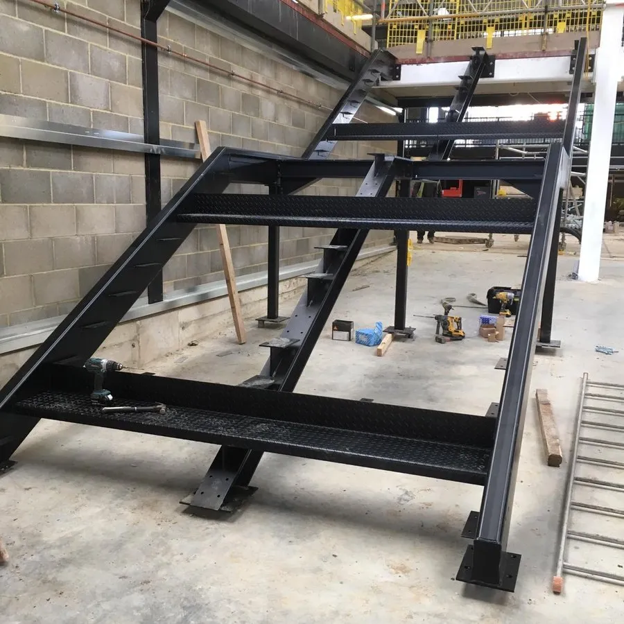 Steel staircase fabrication in Harlow with the stringers welded and primed