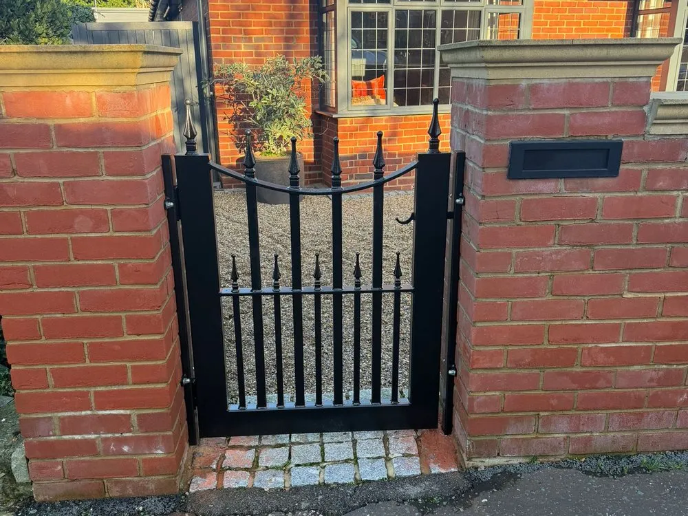 Wrought iron gate to a red brick property