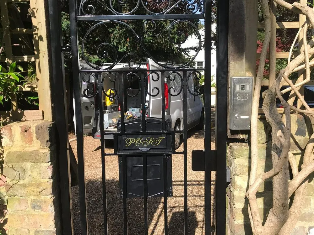 Ornate wrought iron side gate with scrollwork detailing