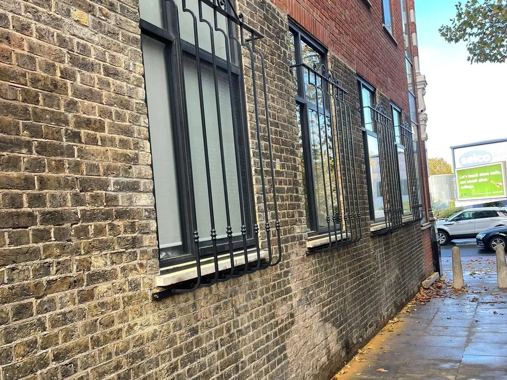 Window security grilles fitted to a brick building