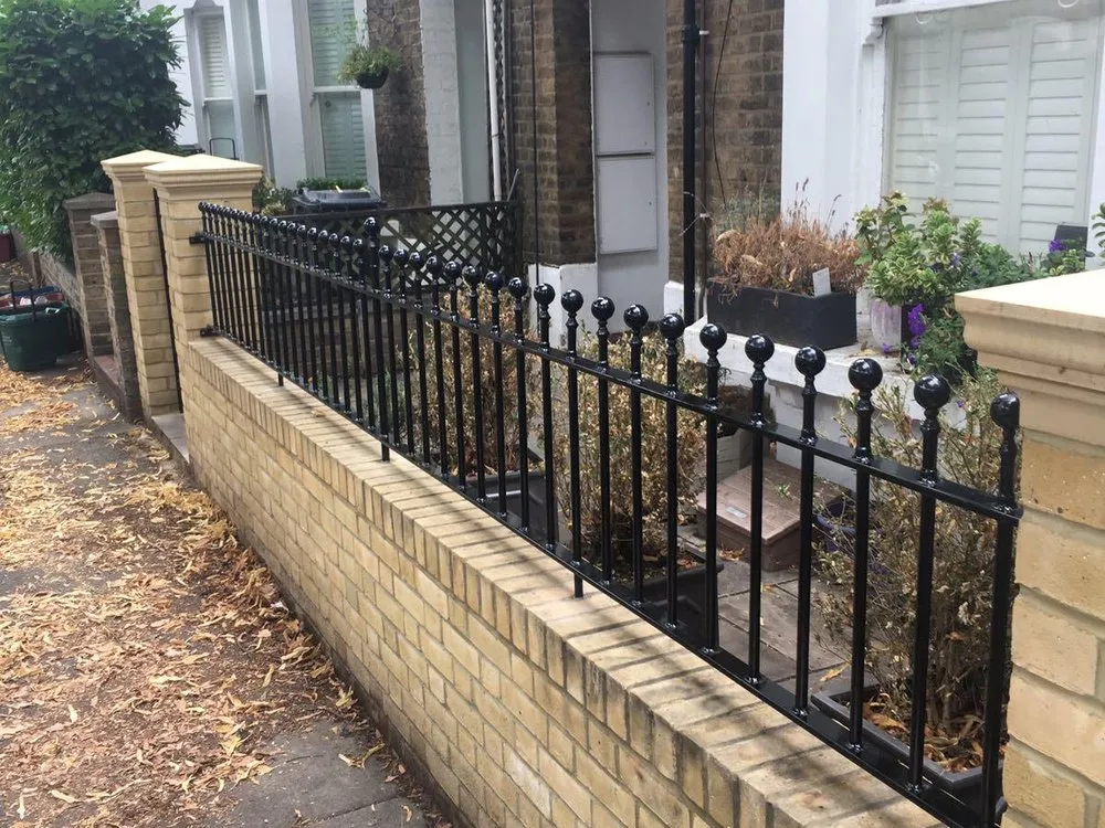 Railings above a rendered garden wall