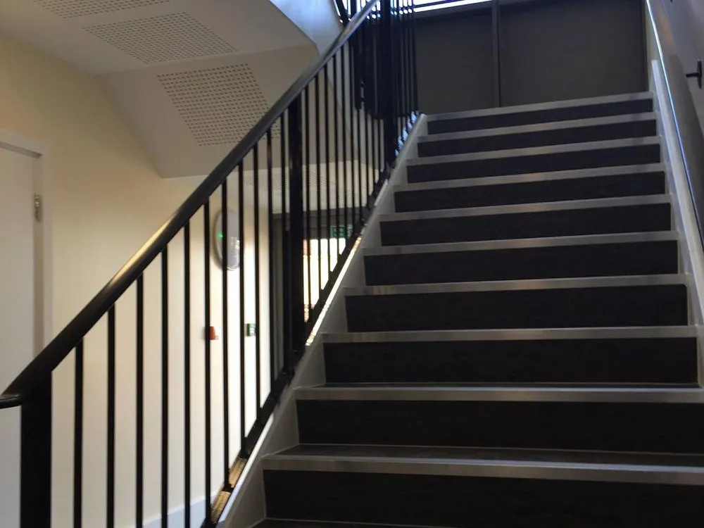 Internal steel staircase with timber treads and a black balustrade